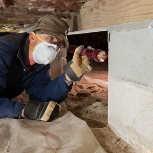 pest control tech inspecting foundation