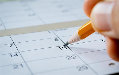 calendar and hand with pencil